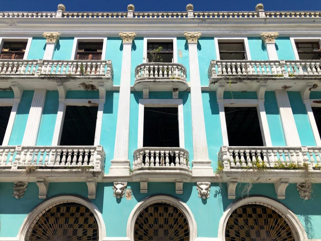 a blue and white building with white balconies