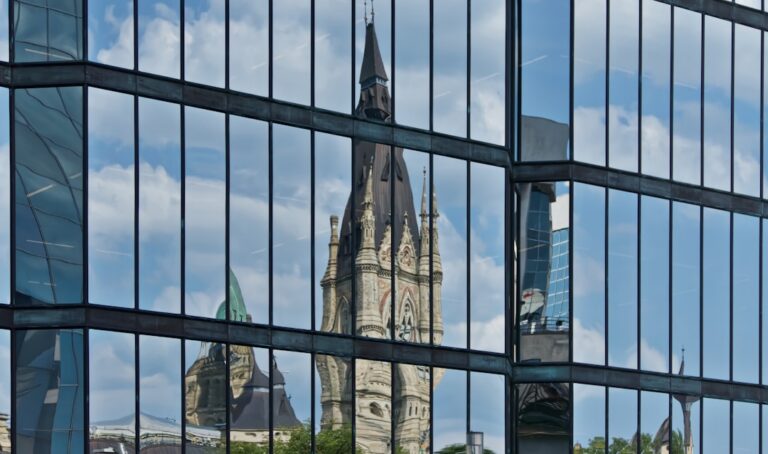 The reflection of a building in the windows of another building